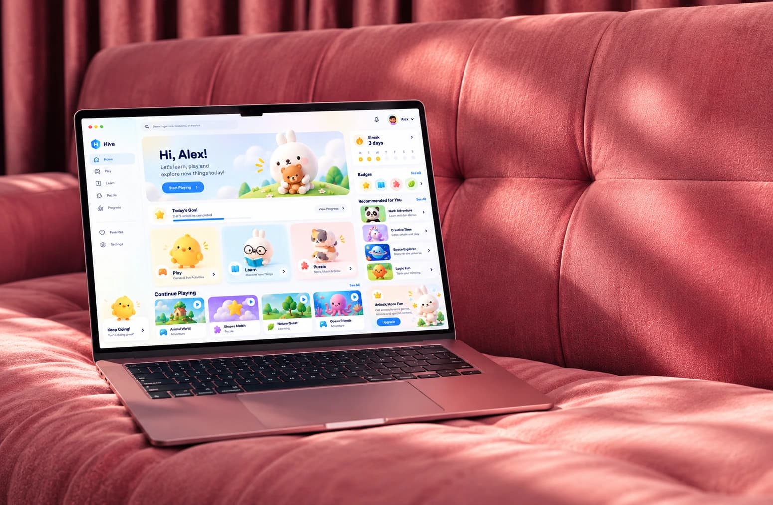 A Hiva home screen on a laptop resting on a pink velvet couch in warm light: a greeting for Alex, a row of Play, Learn and Puzzle cards and the games to carry on with.
