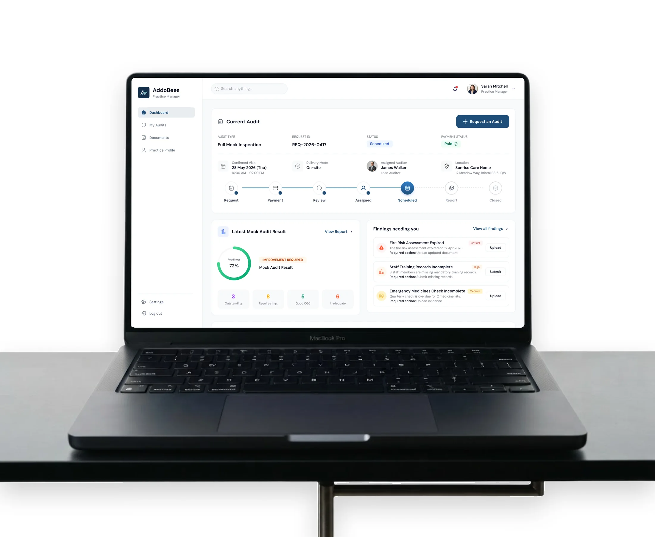 The AddoBees practice dashboard open on a laptop: the current audit at its Scheduled step, the latest mock audit result at 72 percent readiness, and three findings needing action with the response each one requires.
