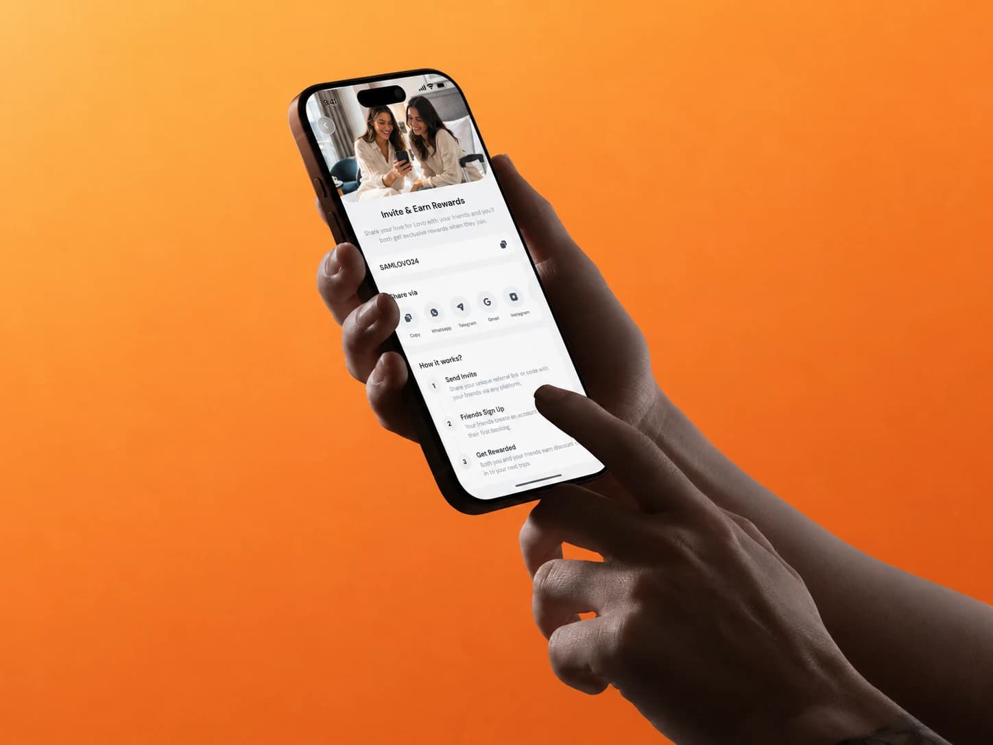 Two hands holding a phone with the Lovo invite and earn rewards screen, against an orange backdrop