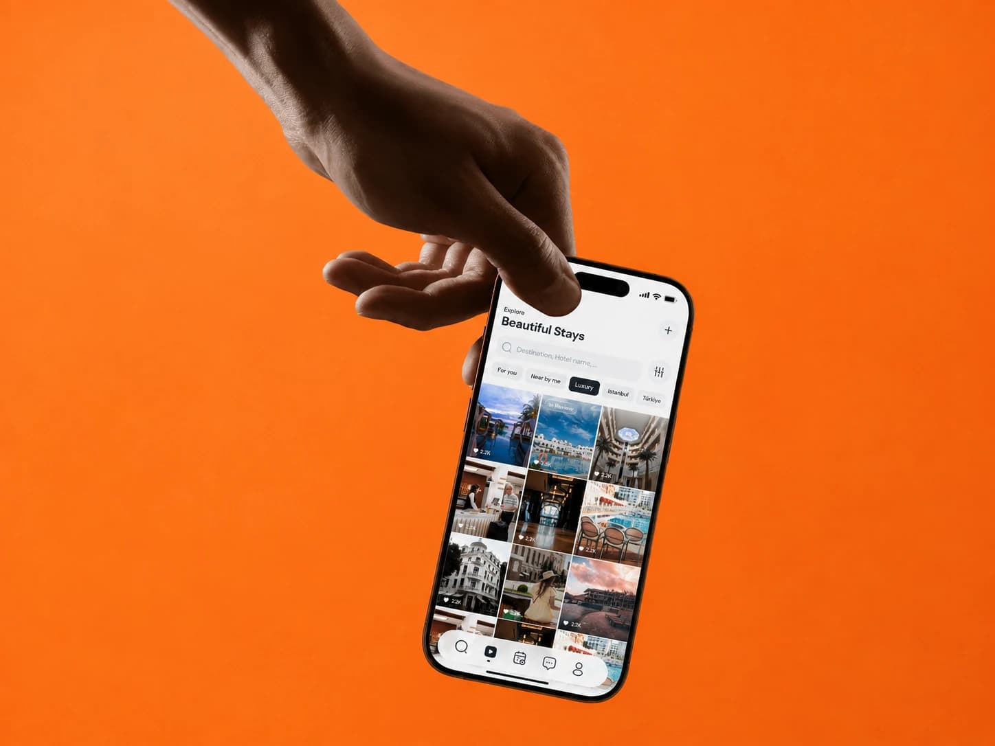 Hand dangling a phone with the Lovo explore screen, against an orange backdrop